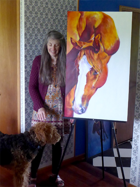 Equine artist Karen Brenner with Blaze painting and her dog Rooney